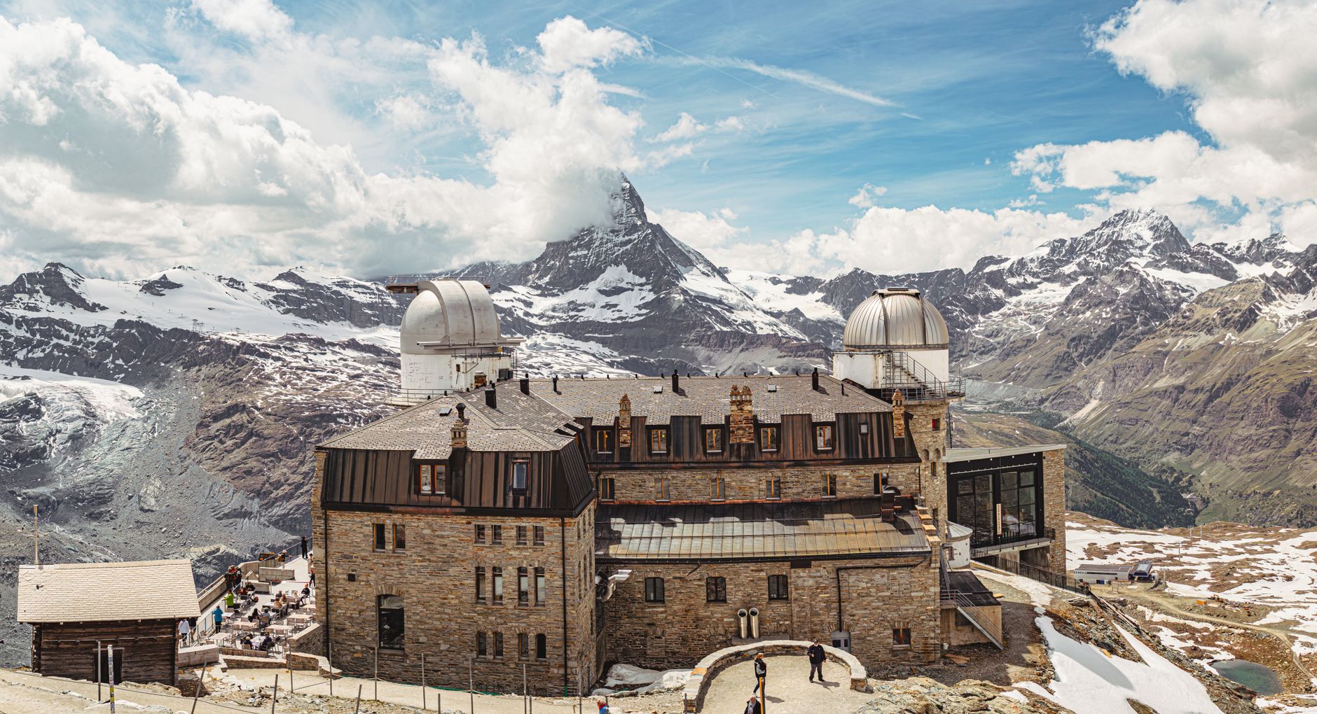 Stunning view of the Gornergrat Observatory with the Matterhorn in the background, showcasing the beauty of Zermatt, Switzerland. — photograph by Christopher Politano on Pexels