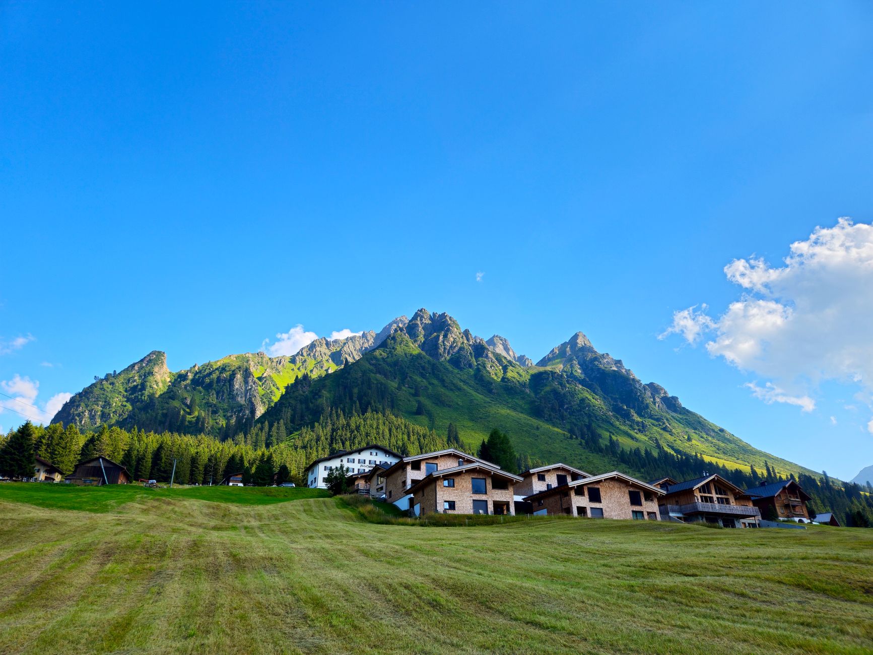 Breathtaking view of the Vorarlberg mountains and alpine village in Austria during summer. — photograph by Christian S. on Pexels