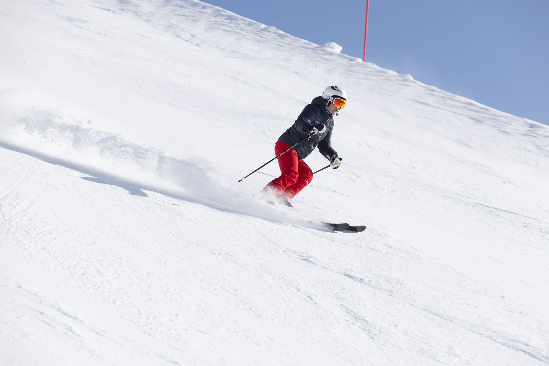 Skier enjoying a thrilling descent on a snowy slope at Ischgl ski resort, Tirol. — photograph by Volker Meyer on Pexels