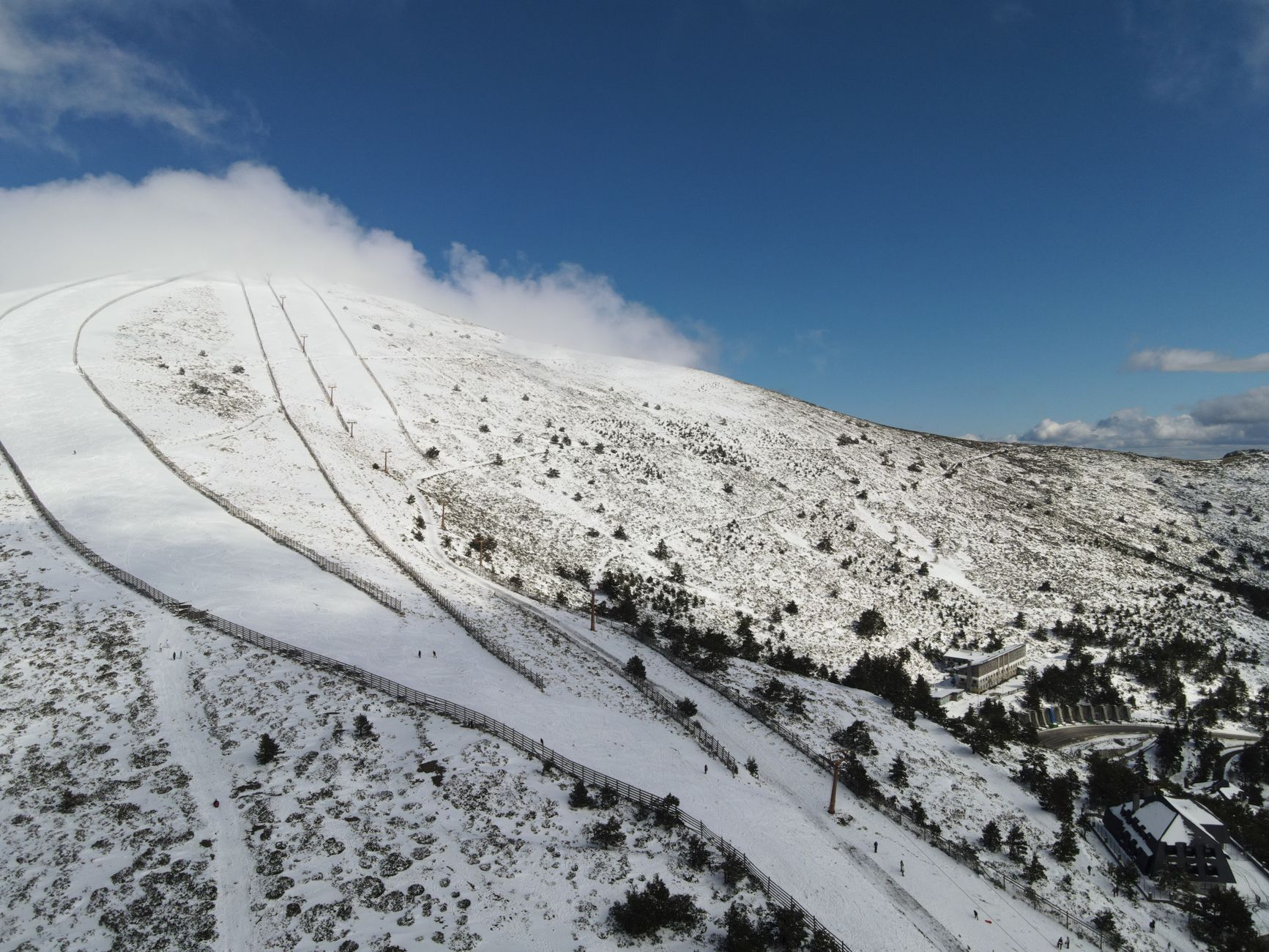 Aerial view of snow-covered mountains and ski slopes in Castilla y León, Spain. — photograph by Pablo Rico on Pexels
