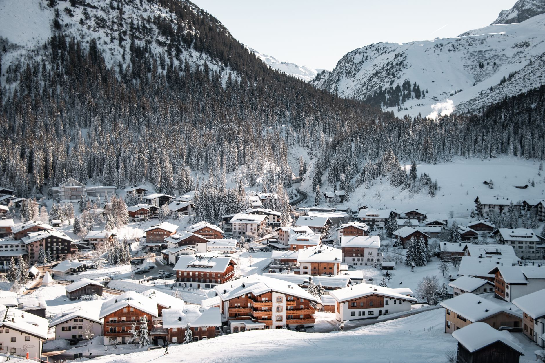 Scenic view of snow-covered village in Lech am Arlberg, Austria with mountains. — photograph by Tobi &Chris on Pexels